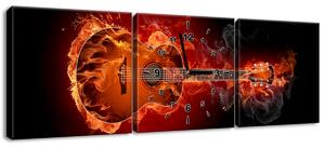Obraz s hodinami Horiaca gitara - 3 dielny Rozmery: 100 x 70 cm