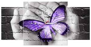 Obraz s hodinami Fialový motýľ na dlaniach - 3 dielny Rozmery: 80 x 40 cm