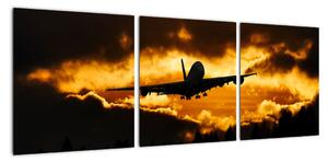 Pristávajúce lietadlo pri západe slnka - obraz (Obraz 90x30cm)