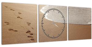 Obraz - stopy v piesku a more (s hodinami) (90x30 cm)