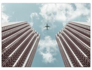 Obraz lietadla medzi budovami (70x50 cm)