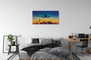 Obraz canvas Veľkomesto oblačnosti lietadlo západ 100x50 cm