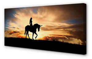 Obraz na plátne Žena na jednorožca západu slnka 100x50 cm