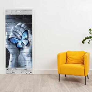 Fototapeta na dvere - Modrý motýľ v dlaniach (95x205cm)