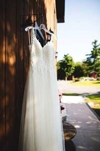 Umelecká fotografie Beautiful white wedding dress hanging elegantly, Wirestock, (26.7 x 40 cm)