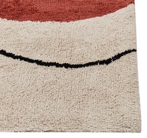 Bavlnený koberec béžový a červený 140 x 200 cm abstraktný vzor strapce nízky vlas moderný dizajn