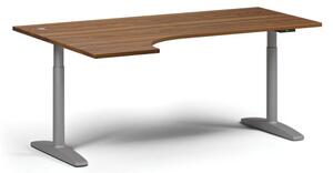 Výškovo nastaviteľný stôl OBOL, elektrický, 675-1325 mm, rohový ľavý, doska 1800x1200 mm, sivá zaoblená podnož, orech