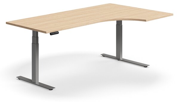 Výškovo nastaviteľný stôl QBUS, rohový, 2000x1200 mm, strieborný rám, dub