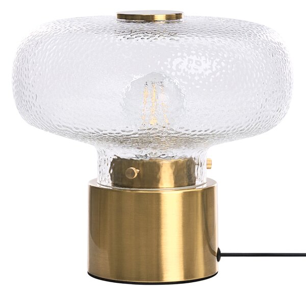 Stolná lampa mosadzná kovová základňa priehľadné tienidlo z textúrovaného skla moderný glamour štýl obývacia izba
