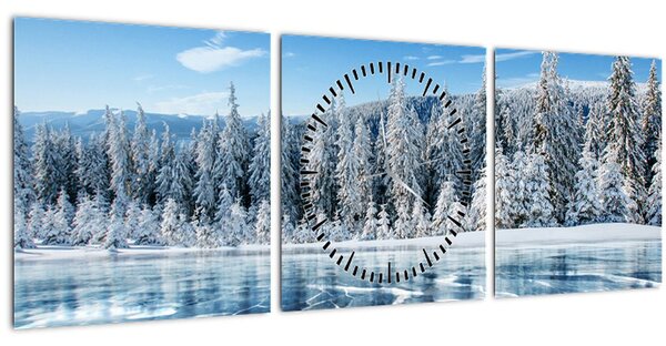 Obraz zamrznutého jazera a zasnežených stromov (s hodinami) (90x30 cm)