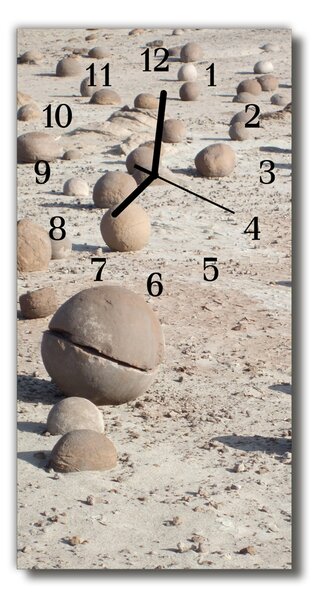 Sklenené hodiny vertikálne Zobraziť kamene na béžovej pláži 30x60 cm