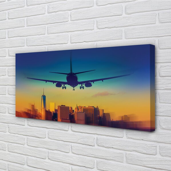 Obraz canvas Veľkomesto oblačnosti lietadlo západ 100x50 cm