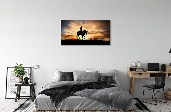 Obraz na plátne Žena na jednorožca západu slnka 100x50 cm