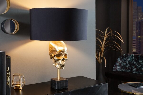 Estila Art deco stolná lampa Uma v zlatom prevedení s kovovou lebkou s čiernym okrúhlym tienidlom 56cm
