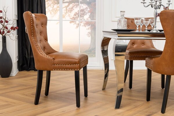 Estila Chesterfield jedálenská stolička Torino s čalúnením z hnedej kože s prešívaným operadlom s čiernymi drevenými nožičkami 93 cm