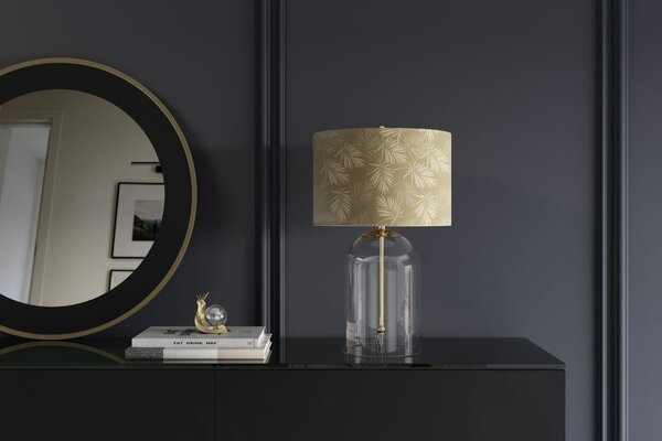 Estila Dizajnová glamour nočná lampa Gambier so zlatým tienidlom so vzorom palmových listov a priehľadnou sklenenou nohou 47 cm