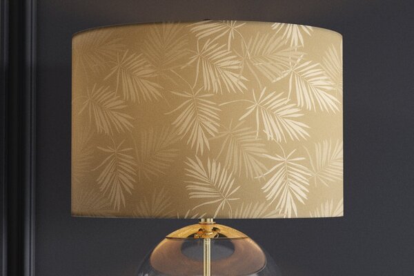 Estila Dizajnová glamour nočná lampa Gambier so zlatým tienidlom so vzorom palmových listov a priehľadnou sklenenou nohou 47 cm