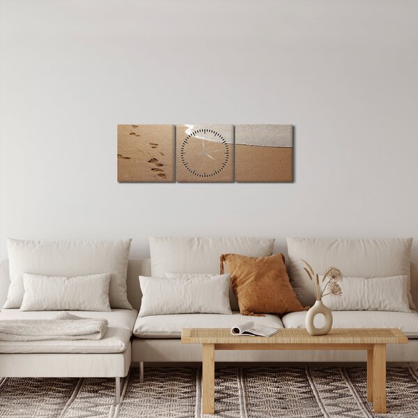 Obraz - stopy v piesku a more (s hodinami) (90x30 cm)