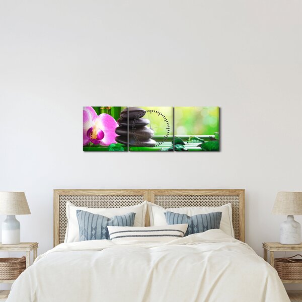 Obraz masážnych kameňov a orchidey na vode (s hodinami) (90x30 cm)