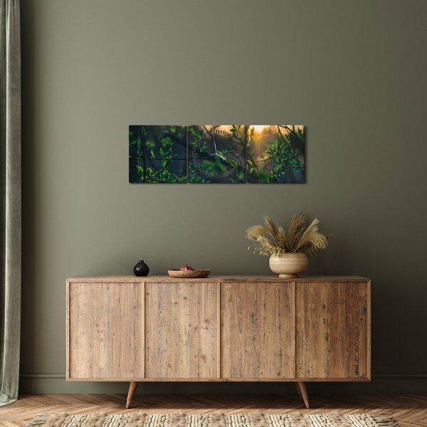 Obraz presvitajúceho slnka cez vetvičky stromov (s hodinami) (90x30 cm)
