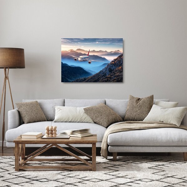 Sklenený obraz - Lietadlo nad vrcholmi hôr (70x50 cm)