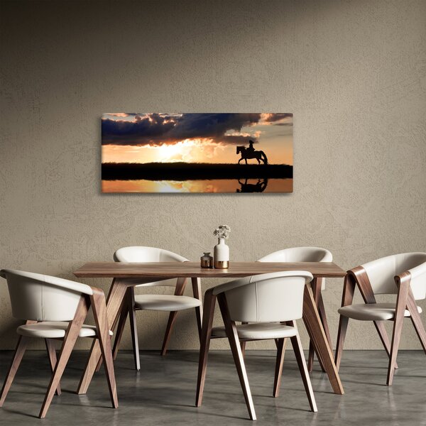Obraz - Jazdec na koni pri západe slnka (120x50 cm)