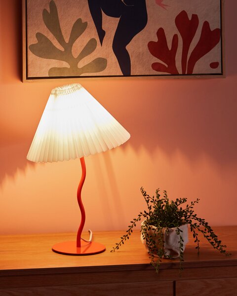 Stolná lampa oranžový kovový podstavec skladané biele tienidlo moderný minimalistický dizajn obývačka spálňa