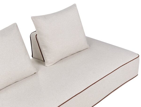 Leňoška svetlobéžová látkové čalúnenie s vankúšmi moderný minimalistický štýl obývacia izba